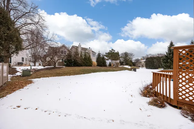 a view of white house with a snow in the yard