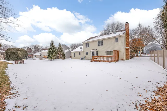 a view of a white house with large windows