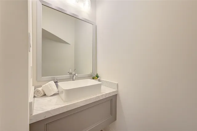 a picture of a bench in front of a wall