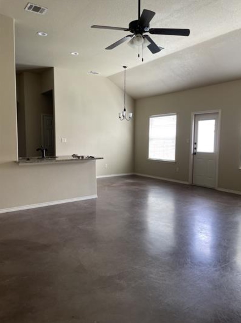 601 Jack Rabbit Lane, Unit B Buda, TX 78610 - Photo 2 of 10 an empty room with wooden floor and windows