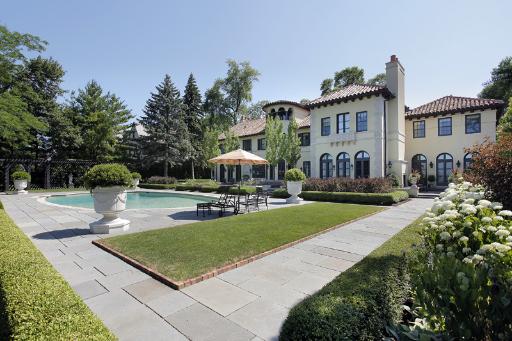 175 Sheridan Road Winnetka, IL 60093 - Photo 15 of 16 a front view of a house with garden and trees