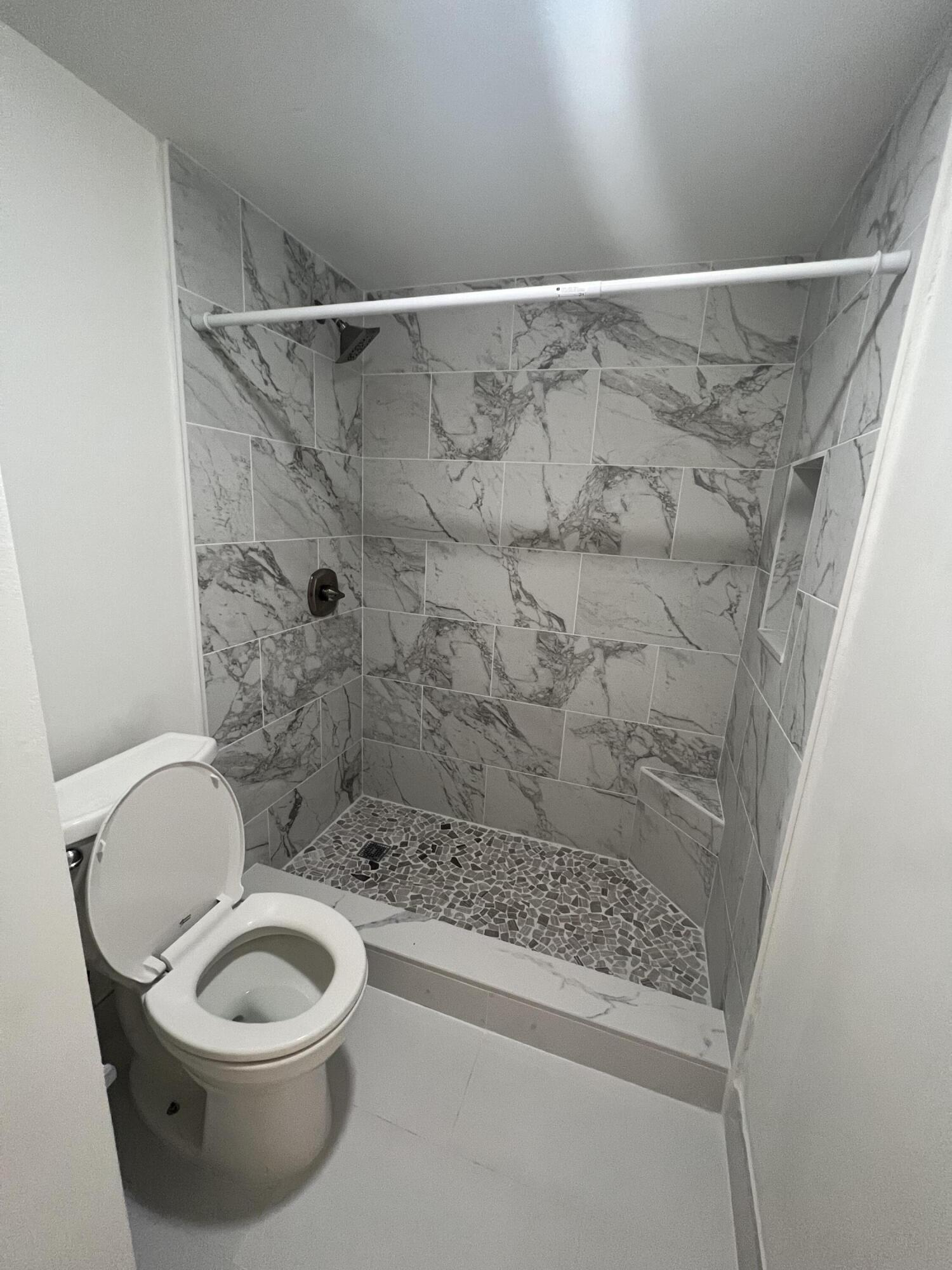 731 Springdale Circle Palm Springs, FL 33461 - Photo 19 of 20 a bathroom with a toilet and a shower