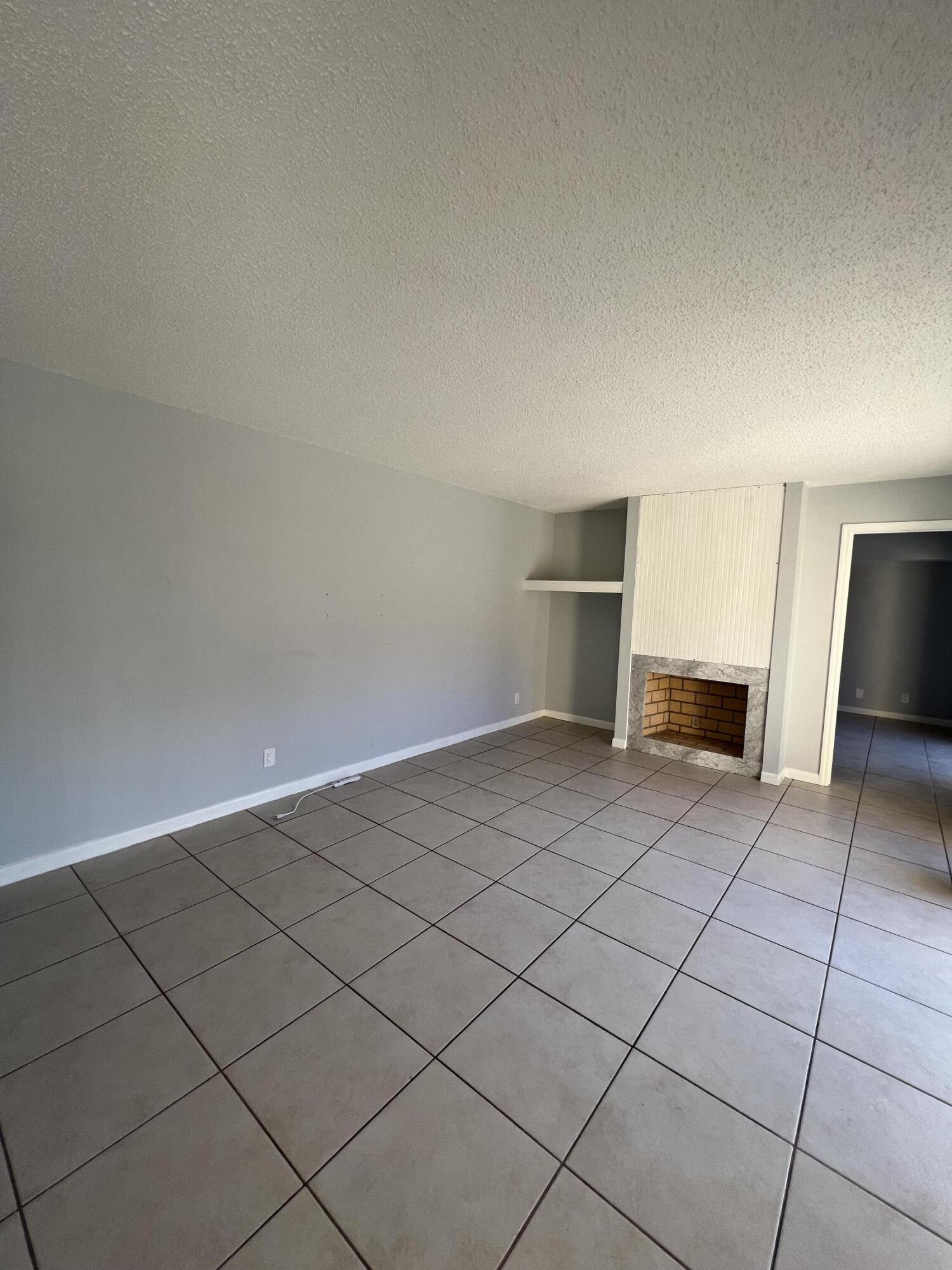 731 Springdale Circle Palm Springs, FL 33461 - Photo 9 of 20 a view of an empty room and fire place