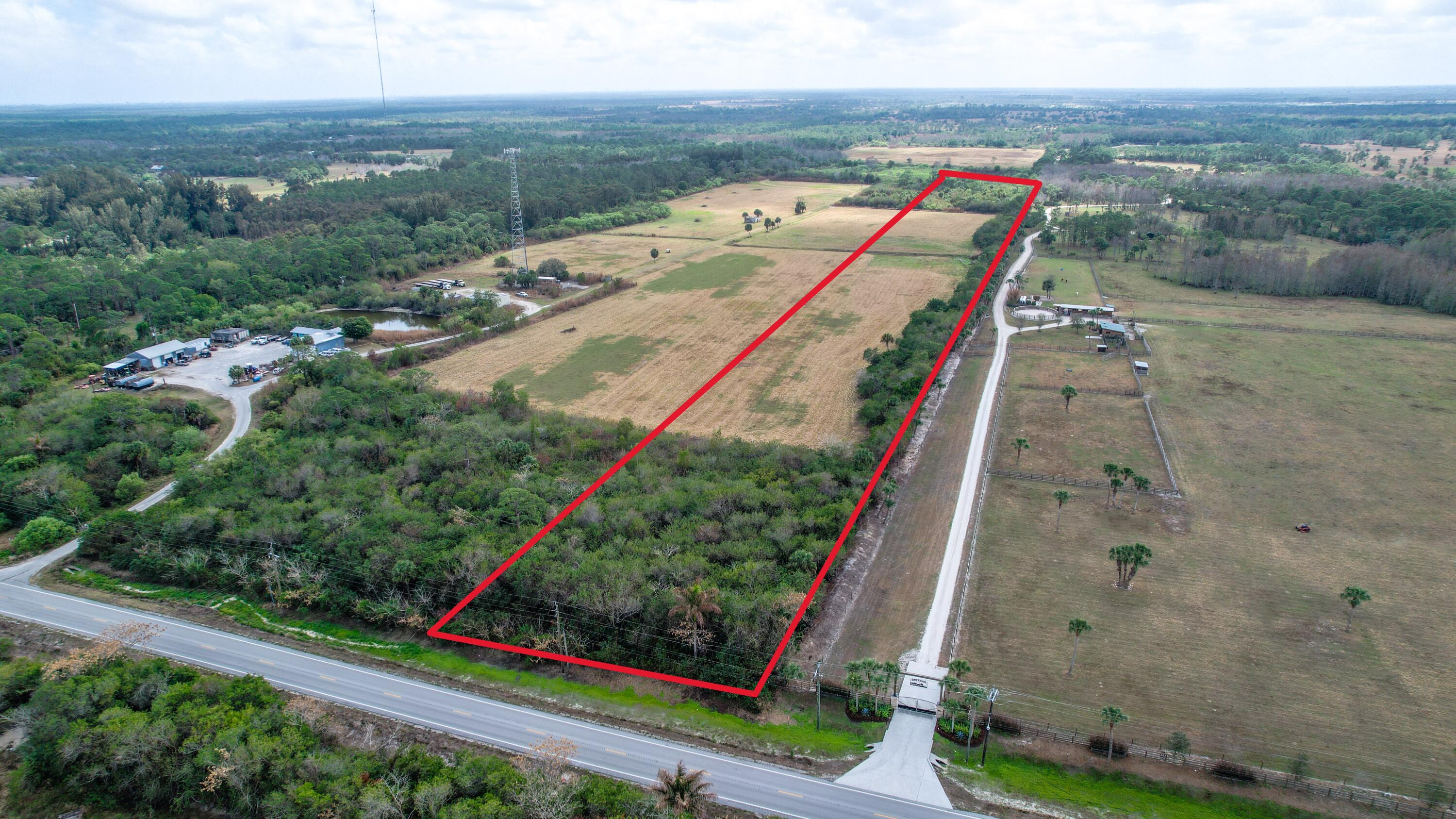0 Southeast Bridge Road Hobe Sound, FL 33455 - Photo 3 of 9 an aerial view of a residential apartment building with a yard