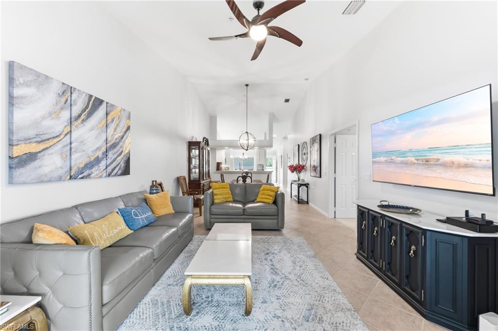 6840 Beach Resort Drive, Unit 16 Naples, FL 34114 - Photo 11 of 49 Living room with ceiling fan, light tile patterned floors, and lofted ceiling