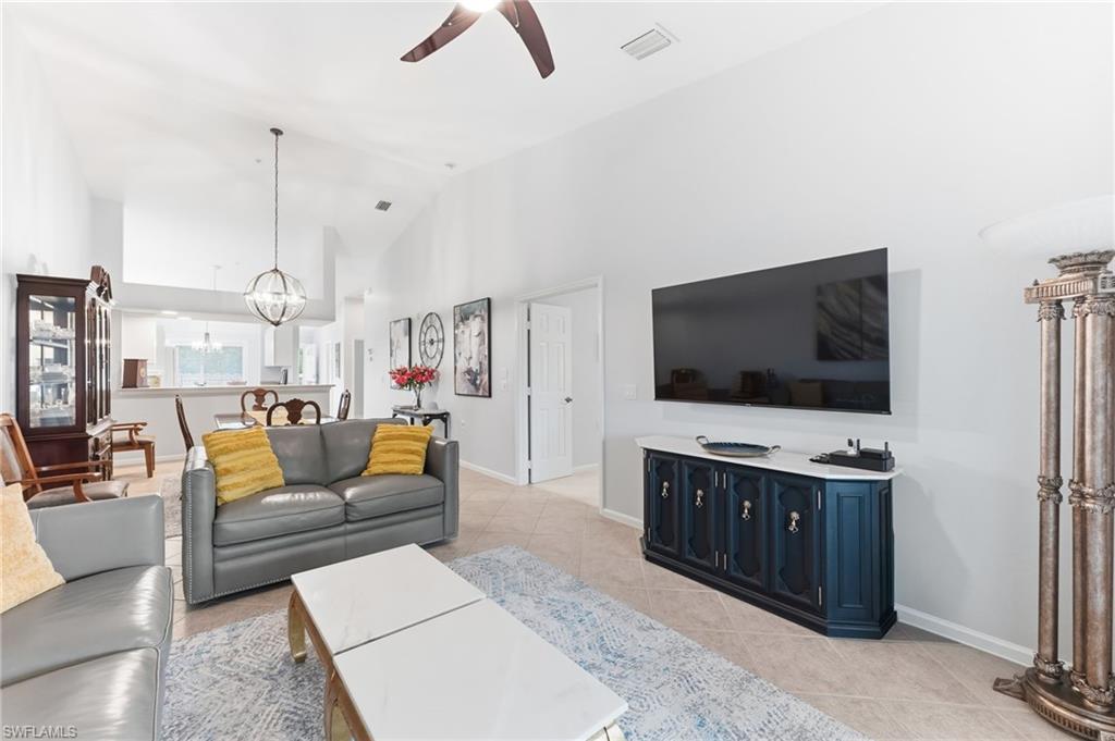 6840 Beach Resort Drive, Unit 16 Naples, FL 34114 - Photo 12 of 49 Living room with hanging lights, ceiling fan, light tile patterned floors, and lofted ceiling