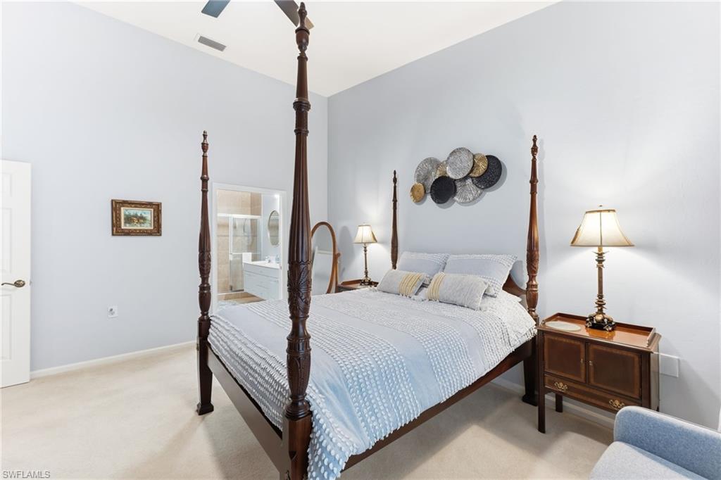 6840 Beach Resort Drive, Unit 16 Naples, FL 34114 - Photo 23 of 49 Bedroom with light carpet, a ceiling fan, and ensuite bath