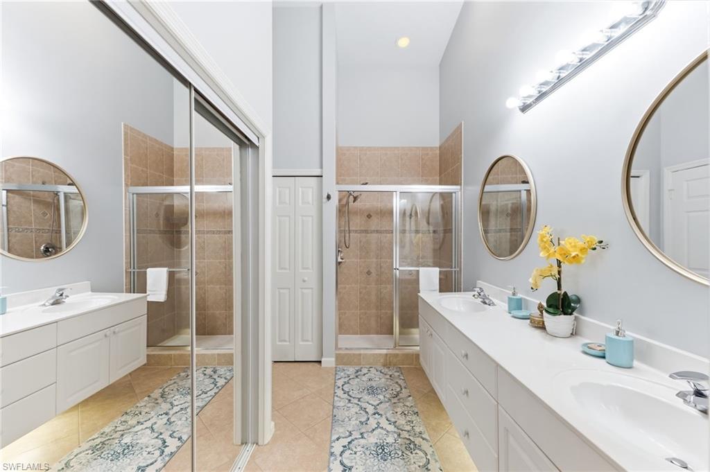 6840 Beach Resort Drive, Unit 16 Naples, FL 34114 - Photo 24 of 49 Full bathroom with double vanity, light tile patterned floors, a stall shower, recessed lighting, and a closet