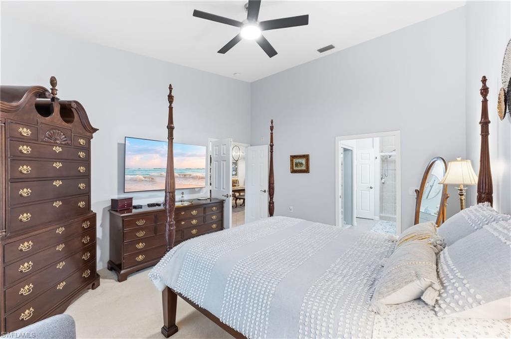 6840 Beach Resort Drive, Unit 16 Naples, FL 34114 - Photo 25 of 49 Bedroom featuring light colored carpet, a high ceiling, and a ceiling fan