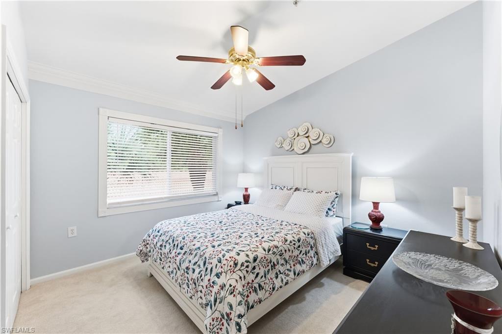 6840 Beach Resort Drive, Unit 16 Naples, FL 34114 - Photo 30 of 49 Bedroom with light carpet, a ceiling fan, a closet, and lofted ceiling