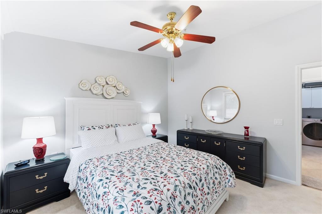 6840 Beach Resort Drive, Unit 16 Naples, FL 34114 - Photo 32 of 49 Bedroom with light carpet, washer / clothes dryer, and a ceiling fan