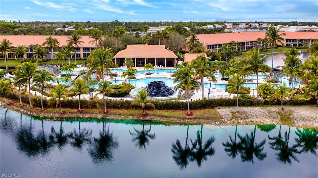 6840 Beach Resort Drive, Unit 16 Naples, FL 34114 - Photo 46 of 49 Aerial view of a pool and a nearby body of water