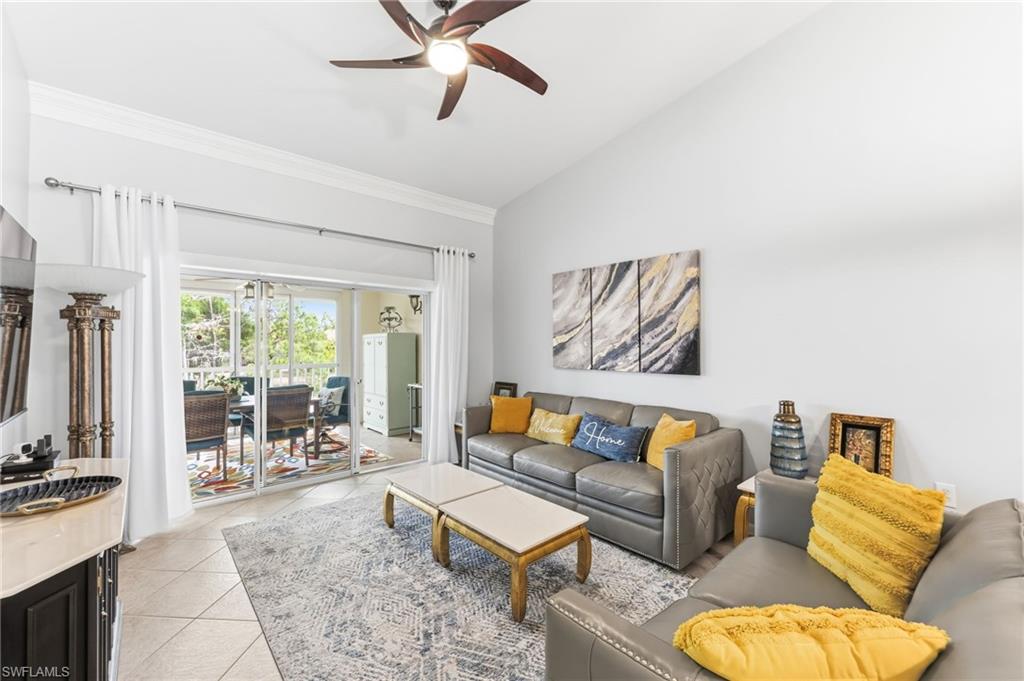 6840 Beach Resort Drive, Unit 16 Naples, FL 34114 - Photo 8 of 49 Living area featuring vaulted ceiling, a ceiling fan, light tile patterned flooring, and ornamental molding