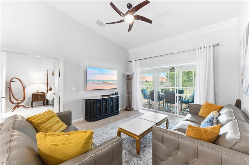 6840 Beach Resort Drive, Unit 16 Naples, FL 34114 - Photo 9 of 49 Living area featuring vaulted ceiling, a ceiling fan, light tile patterned floors, and ornamental molding