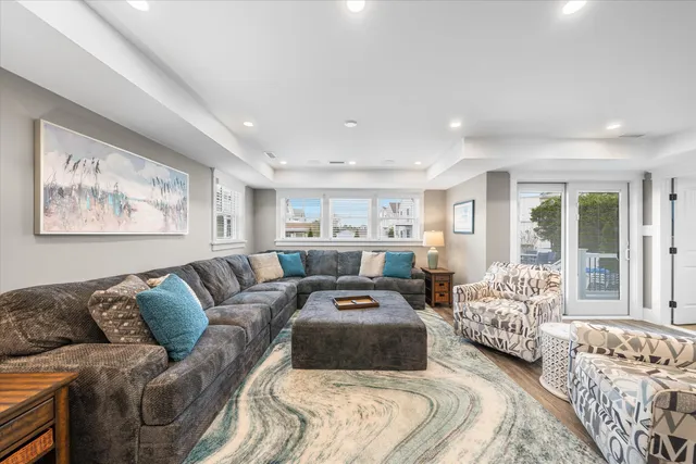 a living room with furniture and large window