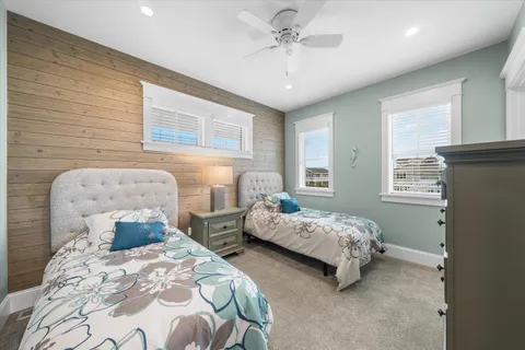 a bedroom with two beds and a chandelier