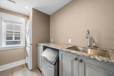 a bathroom with a granite countertop sink and a window