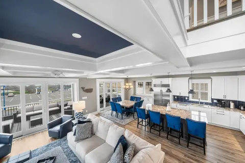 a living room with lots of furniture and kitchen view
