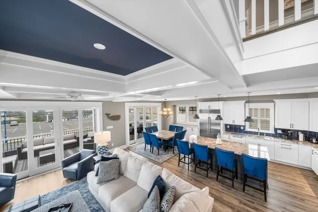 a living room with lots of furniture and kitchen view