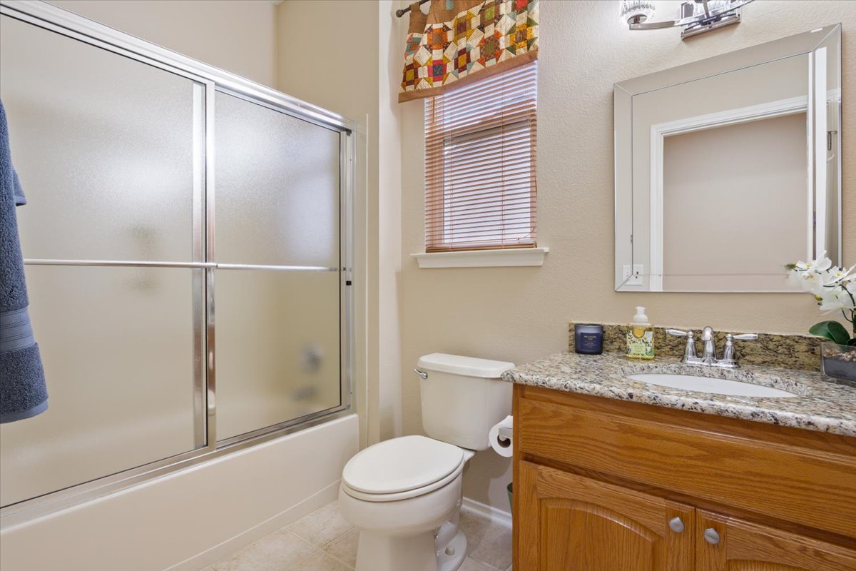 246 Red Poppy Trail Georgetown, TX 78633 - Photo 25 of 32 a bathroom with a granite countertop sink toilet and shower