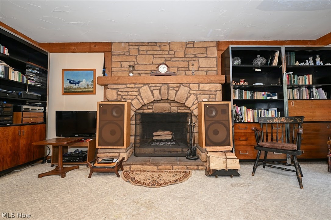 758 Inverness Road Akron, OH 44313 - Photo 20 of 46 Family room with a stone woodburning fireplace and carpet flooring