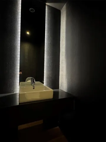 a bathroom with a granite countertop sink a toilet and shower