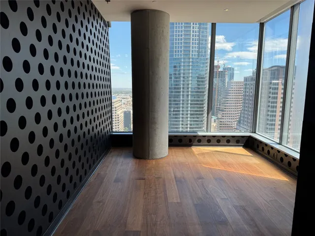 a view of a room with wooden floor and windows