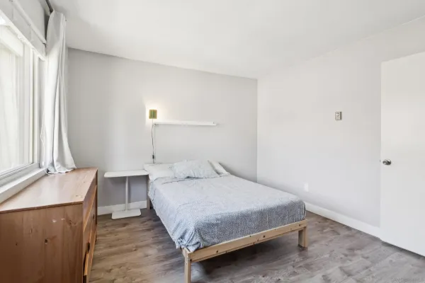 a bedroom with a bed and a table in it