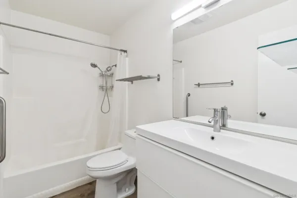 a bathroom with a sink toilet and shower