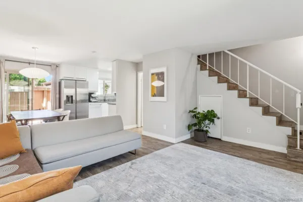 a living room with furniture or wooden floor and a large window