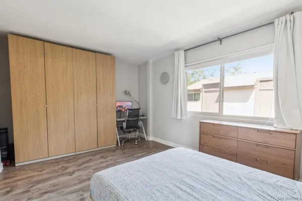 a bedroom with a bed and a window