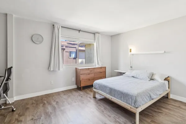 a bedroom with a bed and window