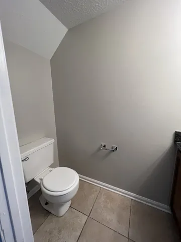 a white toilet sitting next to a shower
