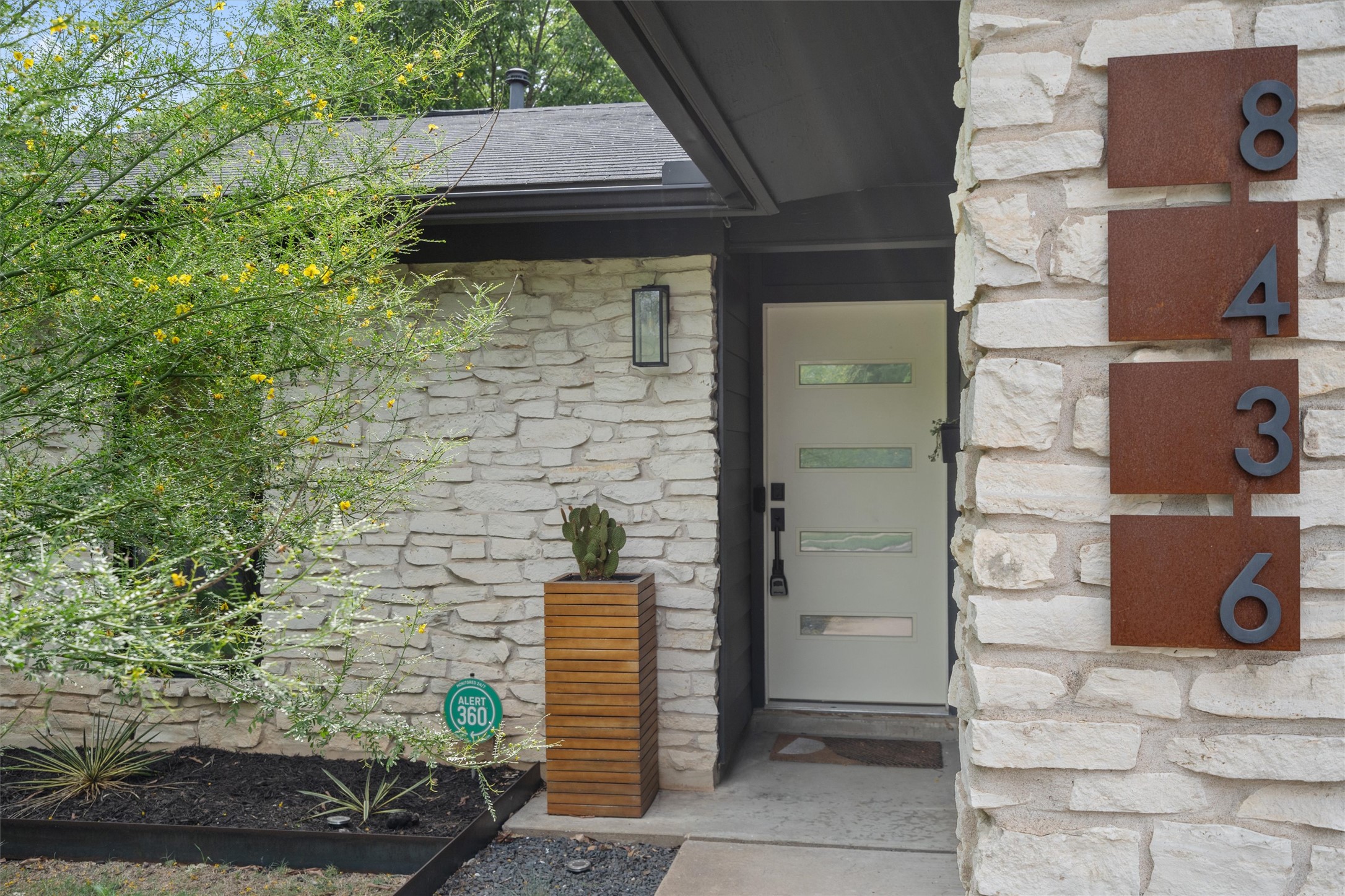 8436 Bangor Bend Austin, TX 78758 - Photo 6 of 29 A front entry with personality, from the stone exterior to the metal house numbers and modern door.