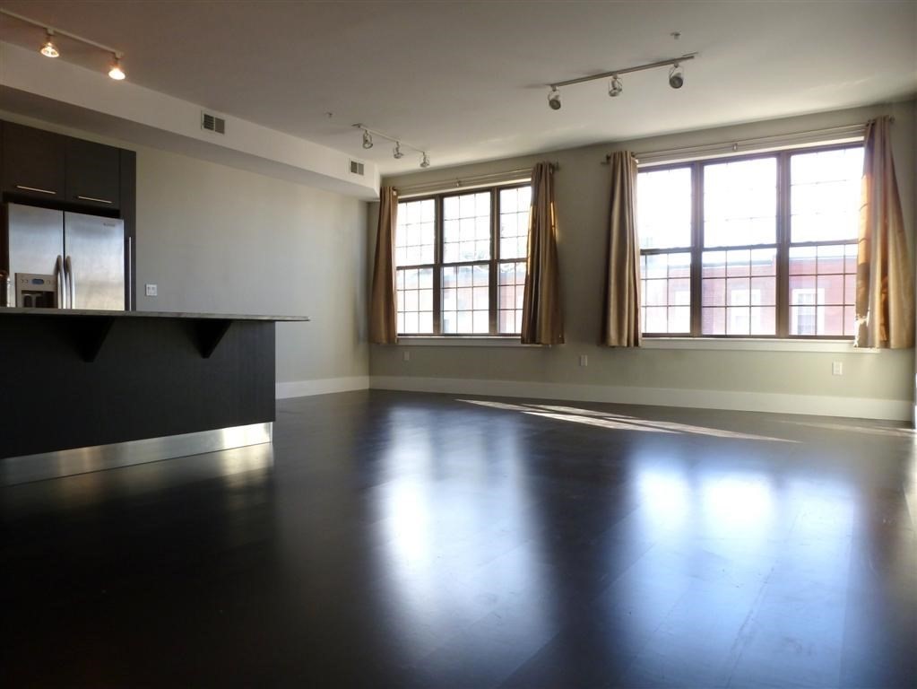 154 West 2nd Street, Unit 301 Boston, MA 02127 - Photo 4 of 13 an empty room with wooden floor and windows