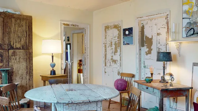 a living room with furniture and a painting on the wall