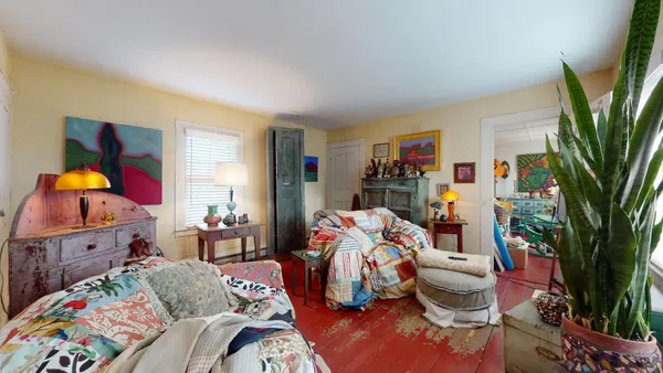 a living room with furniture fireplace and wooden floor