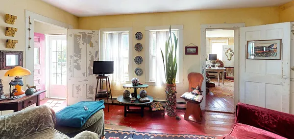 a utility room with lots of clutter and cabinets