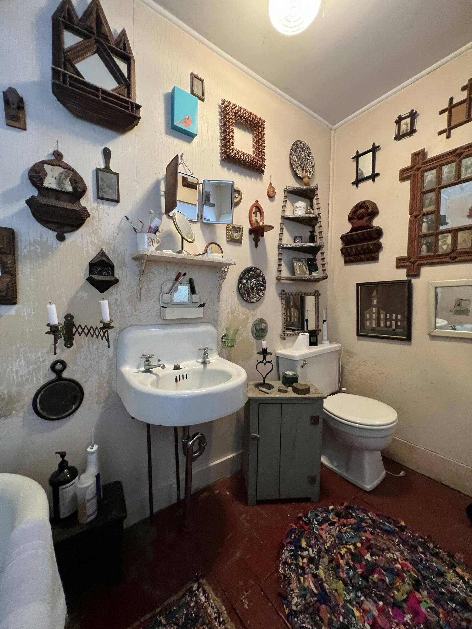 580 Commercial Street Provincetown, MA 02657 - Photo 35 of 58 a bathroom with a toilet a sink and a mirror