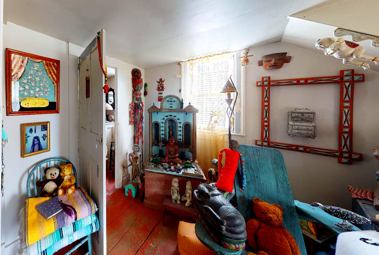 580 Commercial Street Provincetown, MA 02657 - Photo 50 of 58 a living room with lots of furniture and clothes on the wall