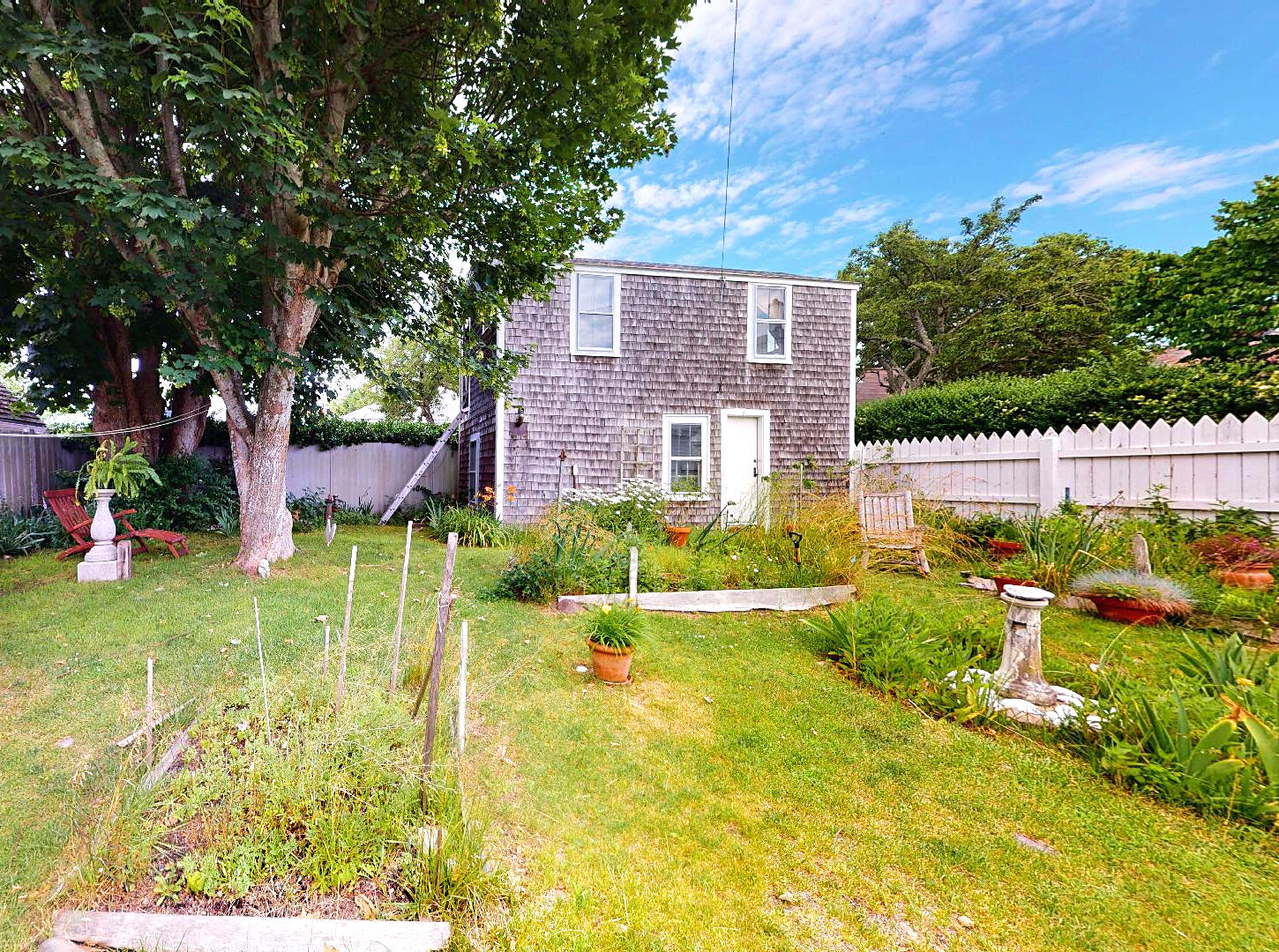 580 Commercial Street Provincetown, MA 02657 - Photo 57 of 58 a view of house with garden space and trees