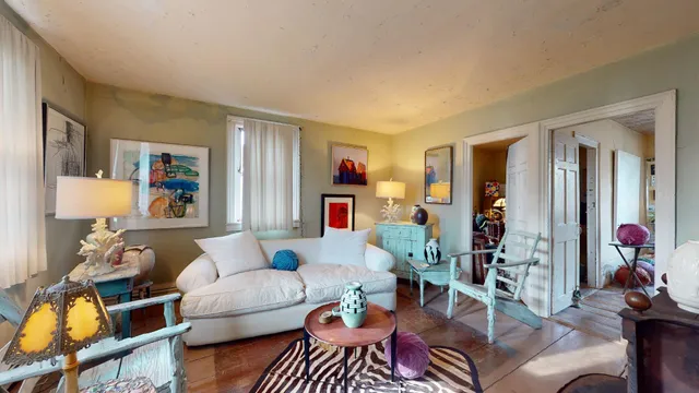 a living room with furniture a rug and a large window
