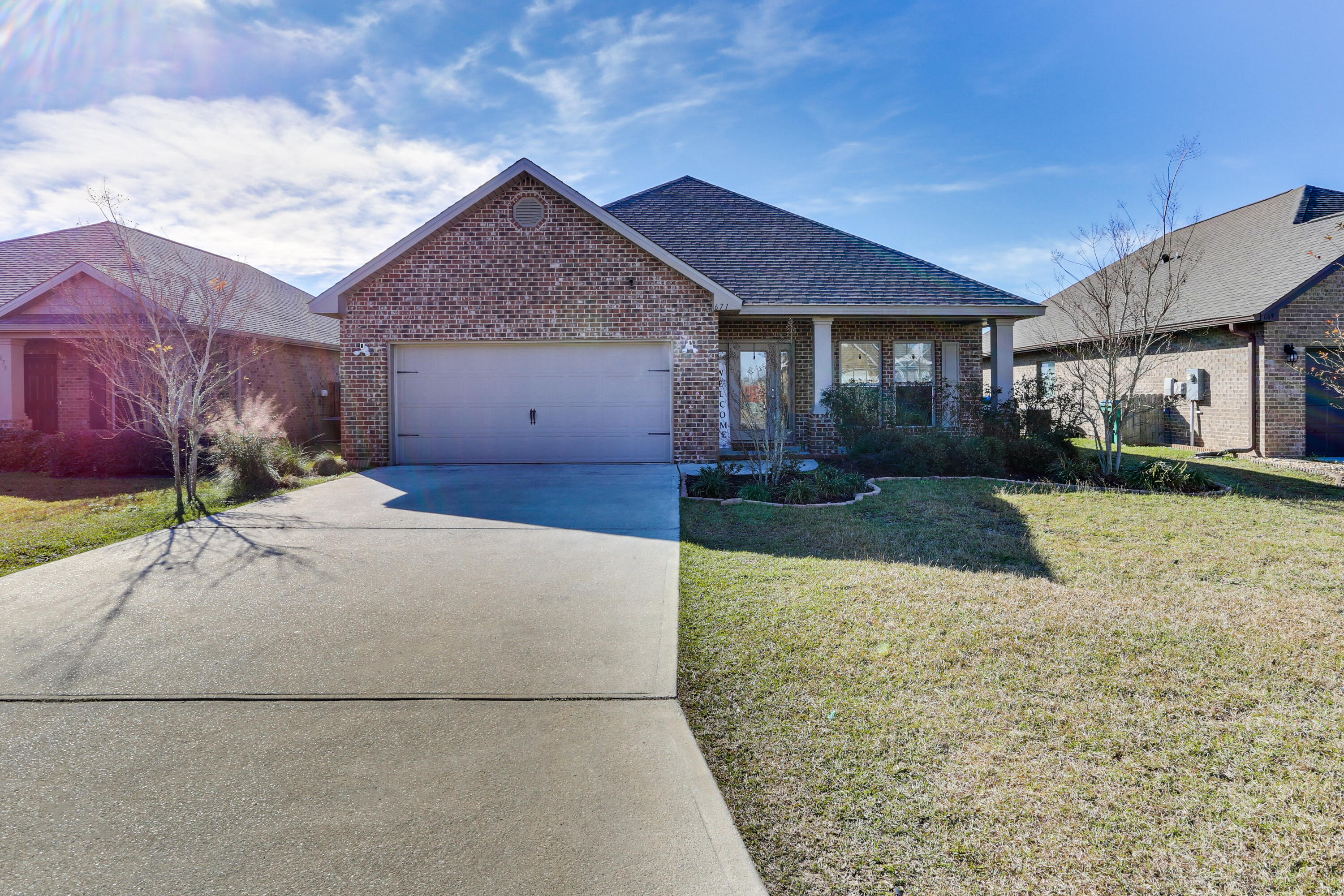 671 Teal Street Crestview, FL 32539 - Photo 1 of 41 a front view of a house with a yard and garage