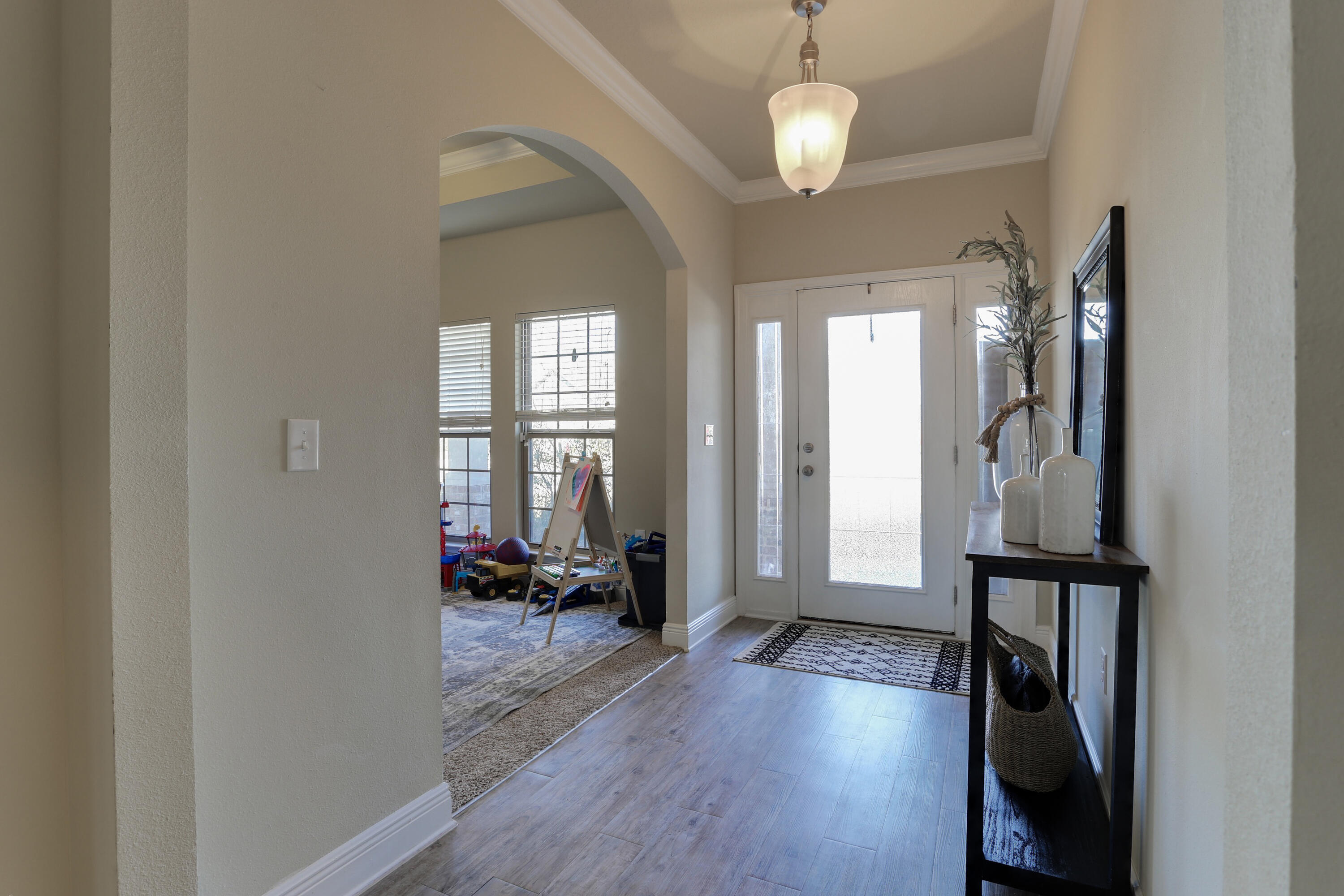 671 Teal Street Crestview, FL 32539 - Photo 11 of 41 a view of a livingroom with wooden floor and windows