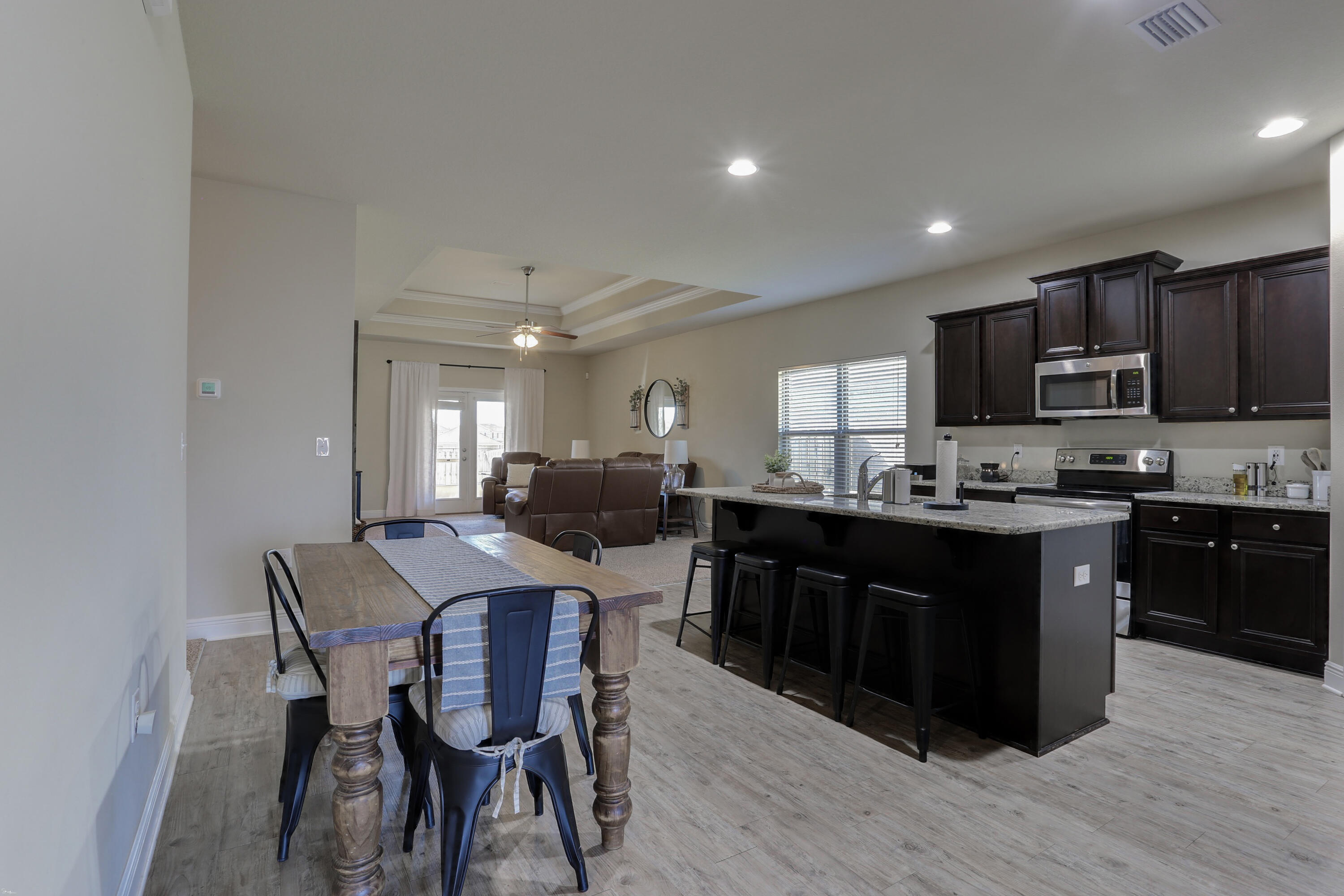 671 Teal Street Crestview, FL 32539 - Photo 13 of 41 a kitchen with stainless steel appliances kitchen island granite countertop a sink counter space and cabinets
