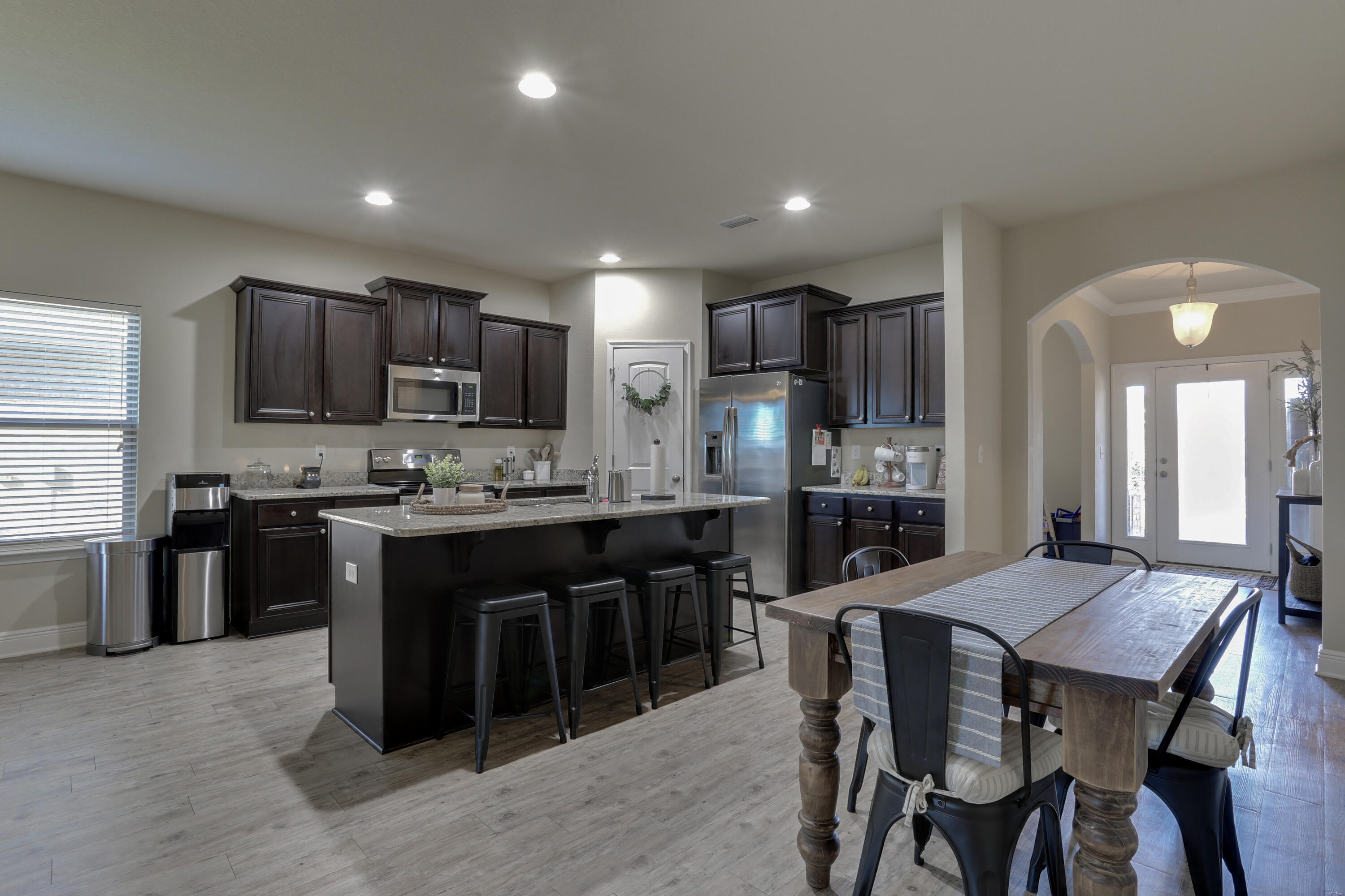 671 Teal Street Crestview, FL 32539 - Photo 15 of 41 a kitchen with kitchen island granite countertop wooden cabinets a counter top space a sink and stainless steel appliances