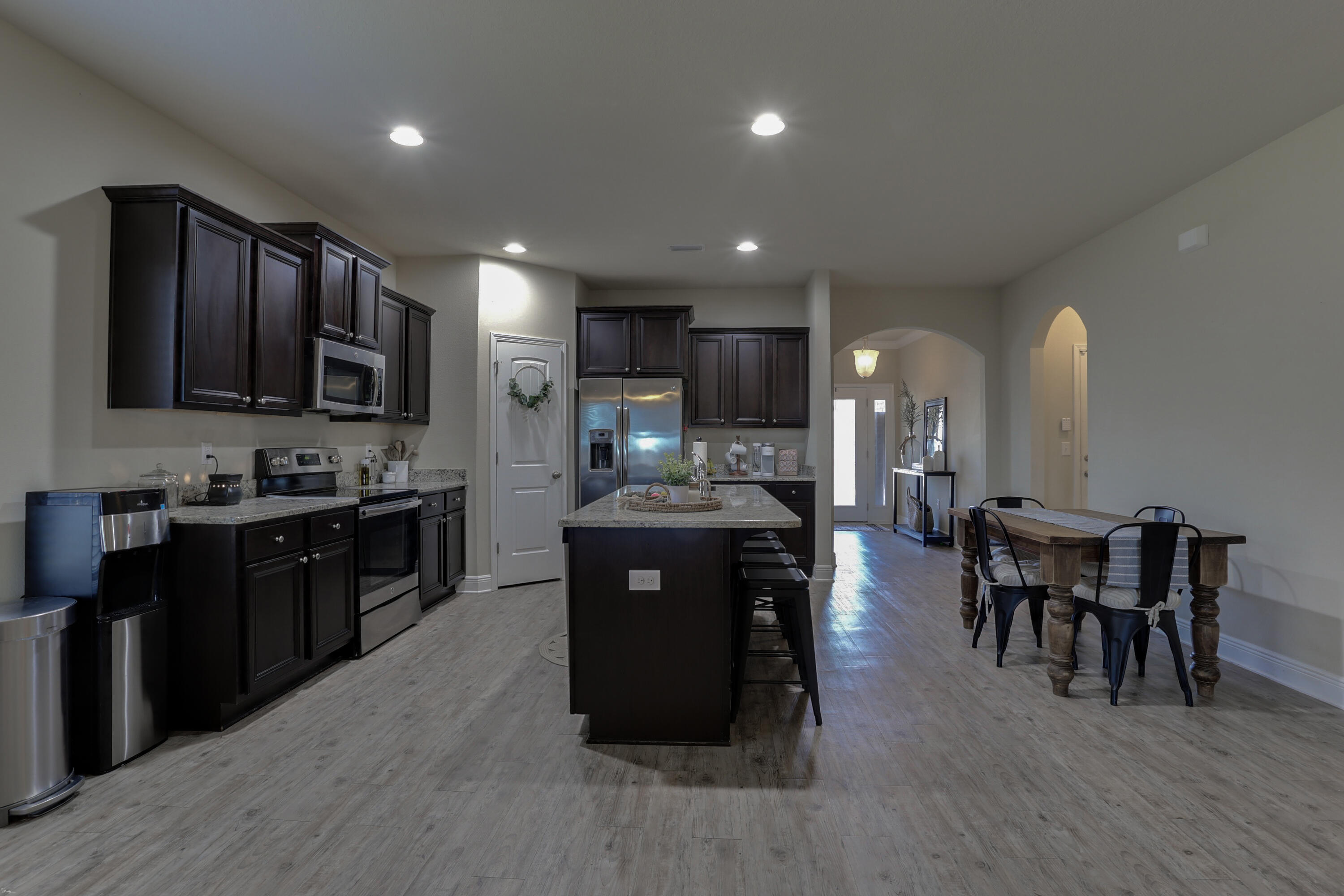 671 Teal Street Crestview, FL 32539 - Photo 16 of 41 a kitchen with stainless steel appliances granite countertop wooden cabinets a refrigerator a stove a sink and a microwave