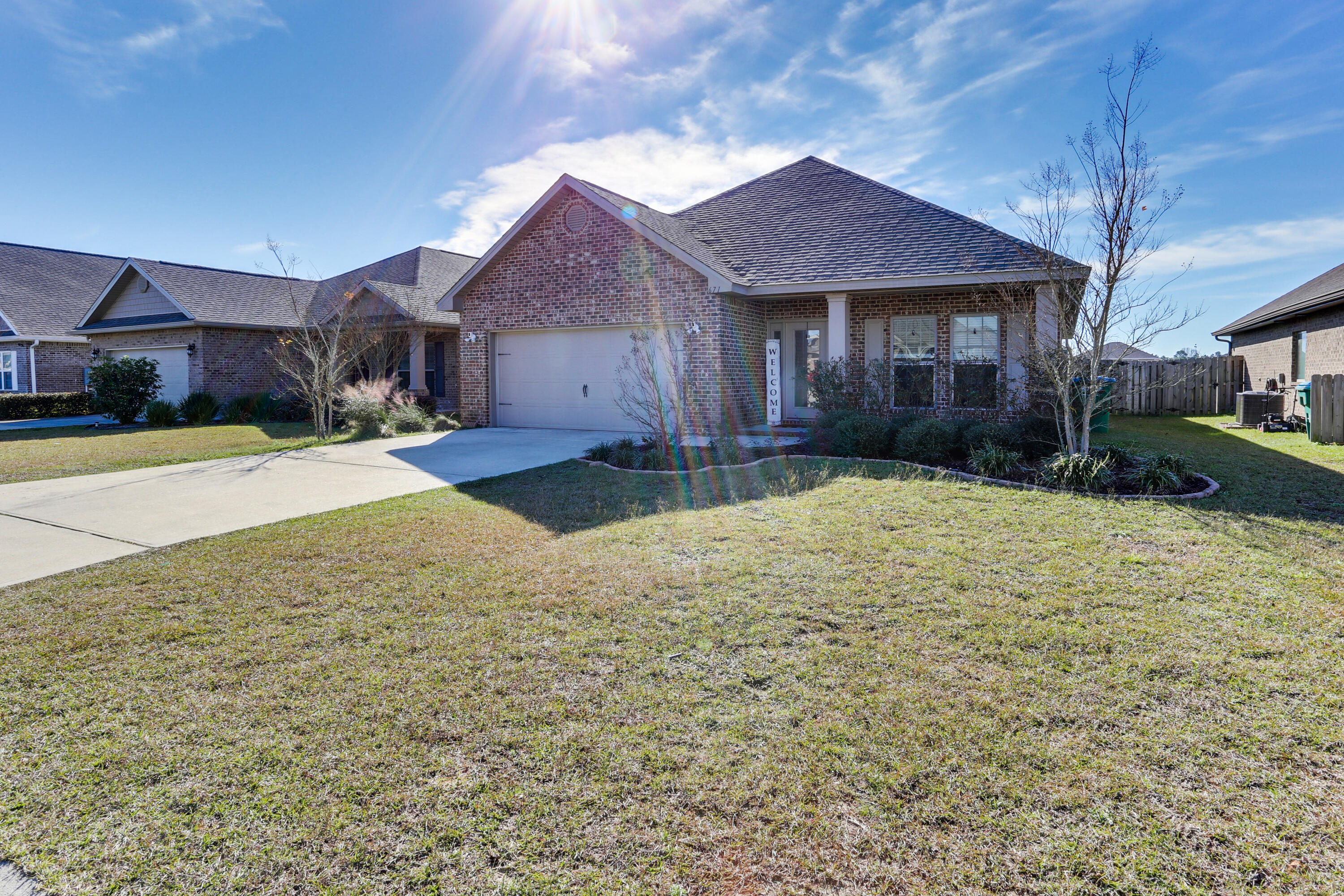 671 Teal Street Crestview, FL 32539 - Photo 2 of 41 a front view of a house with a yard and garage