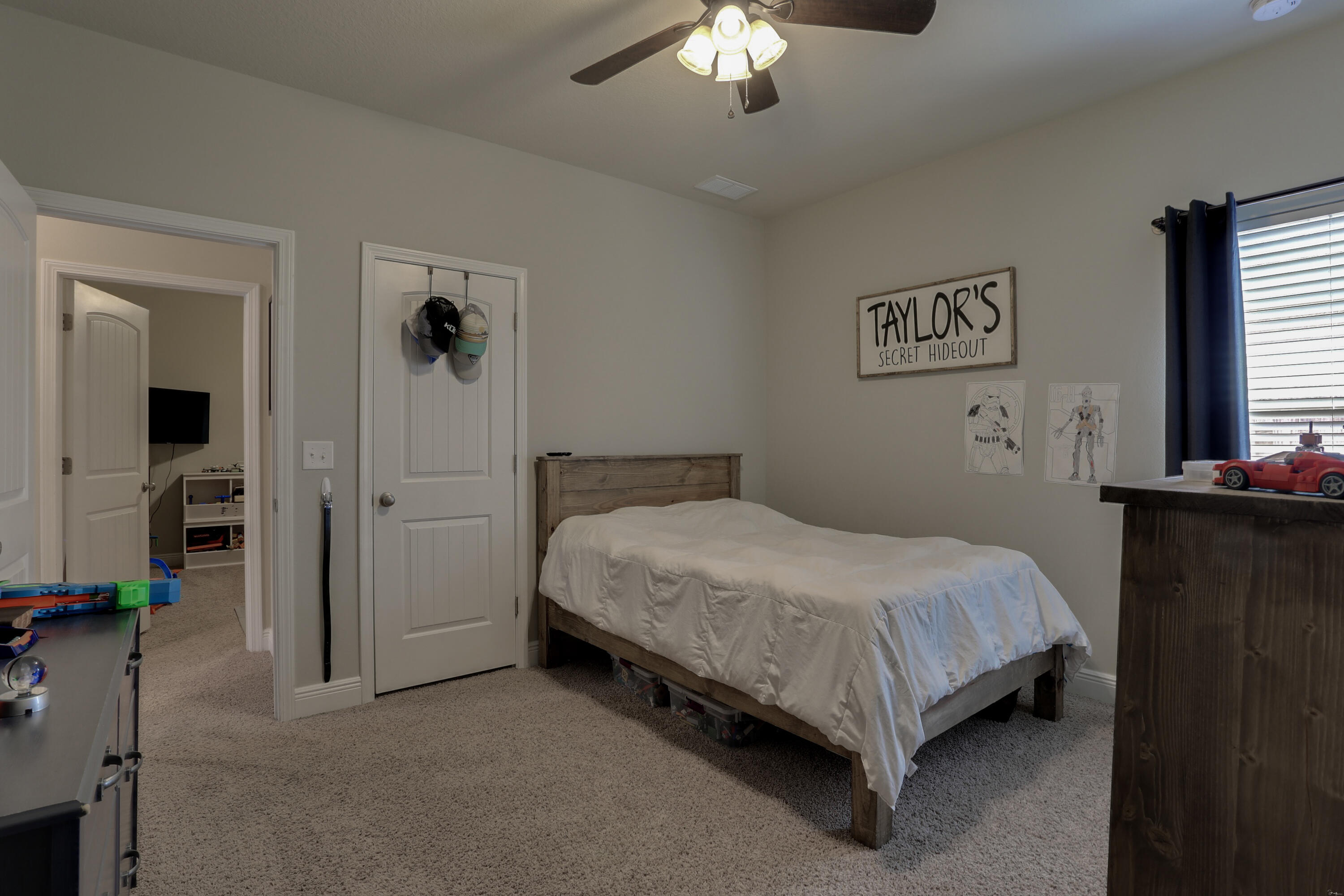 671 Teal Street Crestview, FL 32539 - Photo 22 of 41 a spacious bedroom with a bed and a chandelier