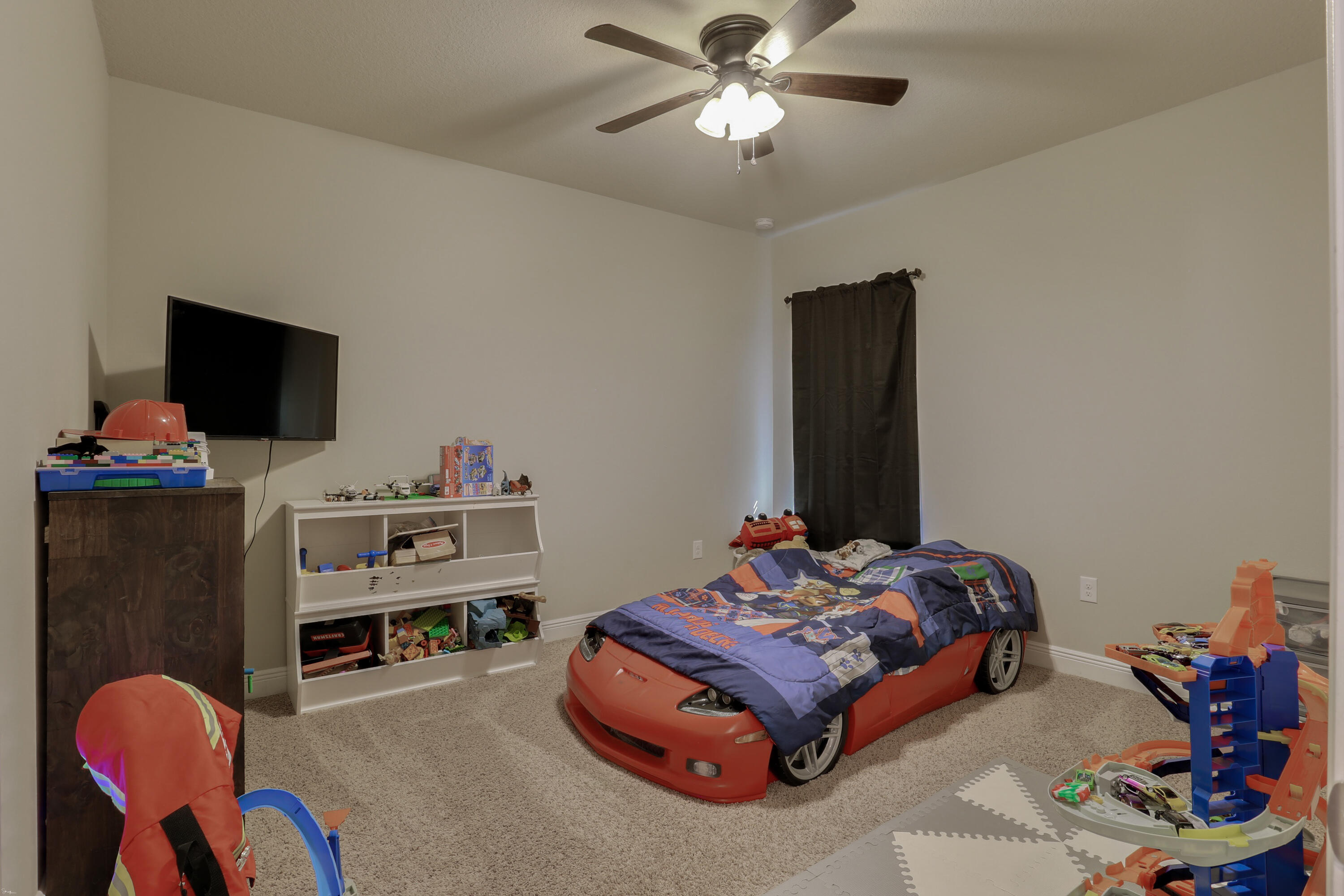 671 Teal Street Crestview, FL 32539 - Photo 23 of 41 a bedroom with a bed and a flat screen tv